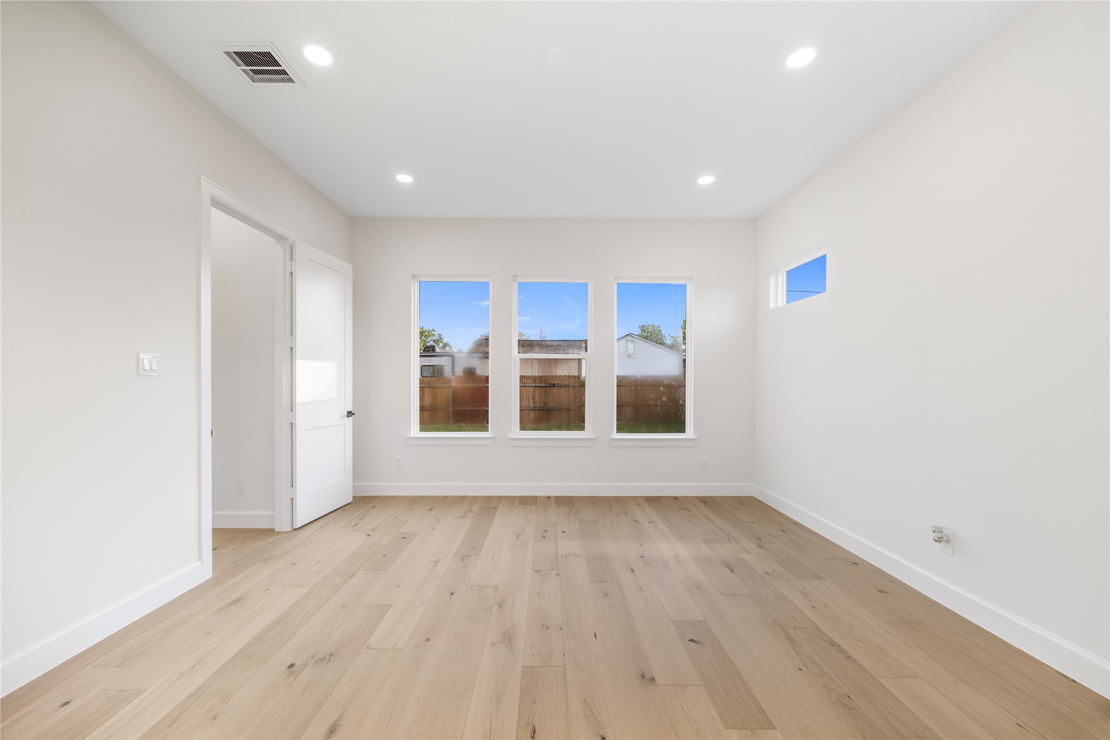 8646 Alcott Drive Houston, TX 77080 - Photo 17 of 44 a view of a big room with wooden floor and windows