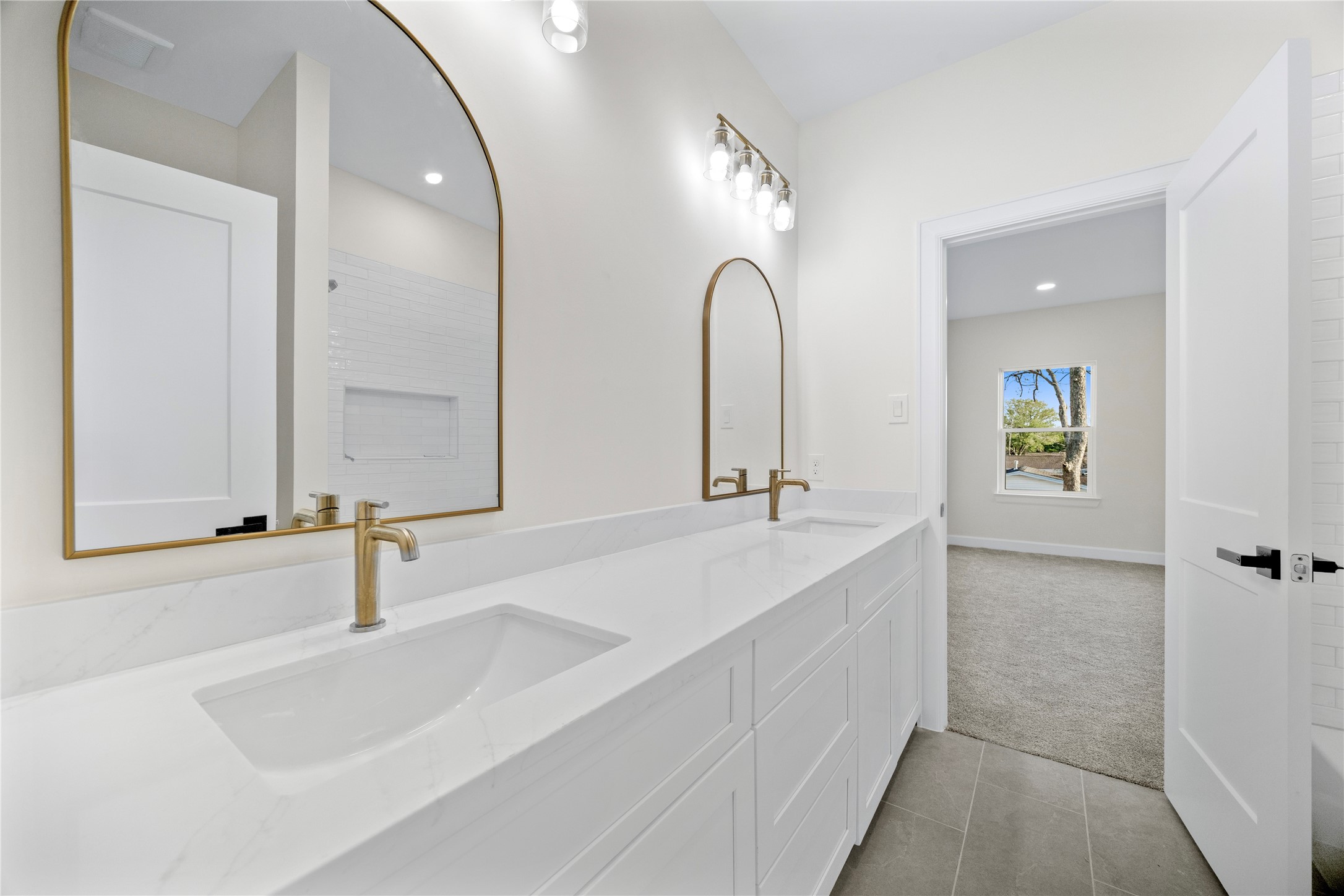 8646 Alcott Drive Houston, TX 77080 - Photo 34 of 44 a bathroom with a double vanity sink and a mirror