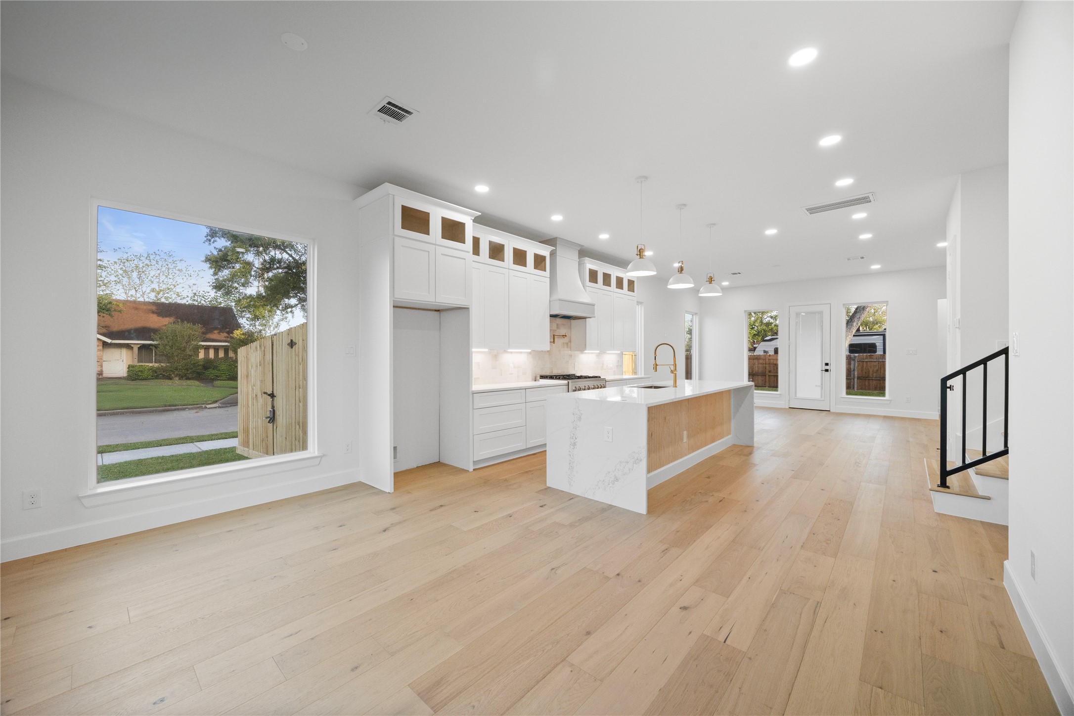 8646 Alcott Drive Houston, TX 77080 - Photo 4 of 44 a view of a kitchen with kitchen island wooden floors and stainless steel appliances