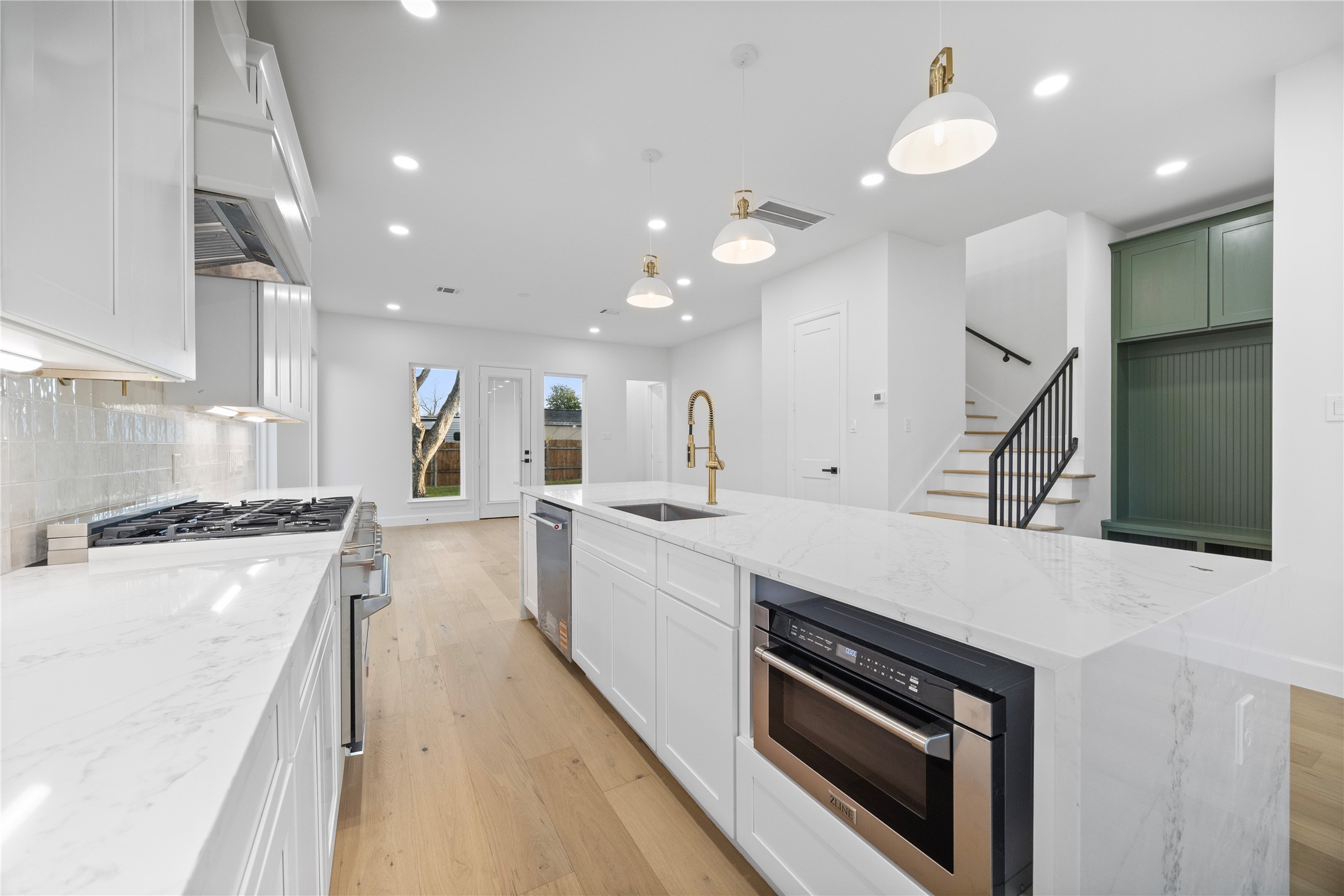 8646 Alcott Drive Houston, TX 77080 - Photo 6 of 44 a large kitchen with stainless steel appliances a large counter top a stove and a refrigerator