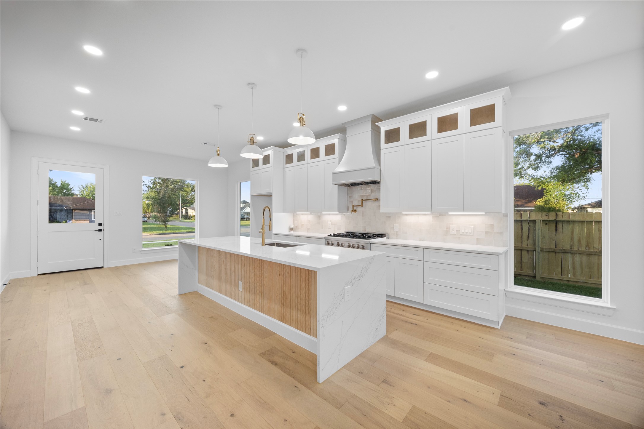 8646 Alcott Drive Houston, TX 77080 - Photo 9 of 44 a large kitchen with kitchen island a sink stainless steel appliances and cabinets
