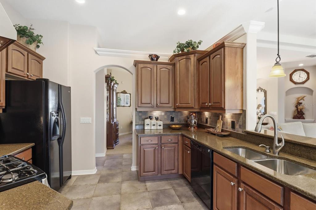 6 Carnation Court Homosassa, FL 34446 - Photo 18 of 48 a kitchen with kitchen island granite countertop a sink stainless steel appliances and cabinets
