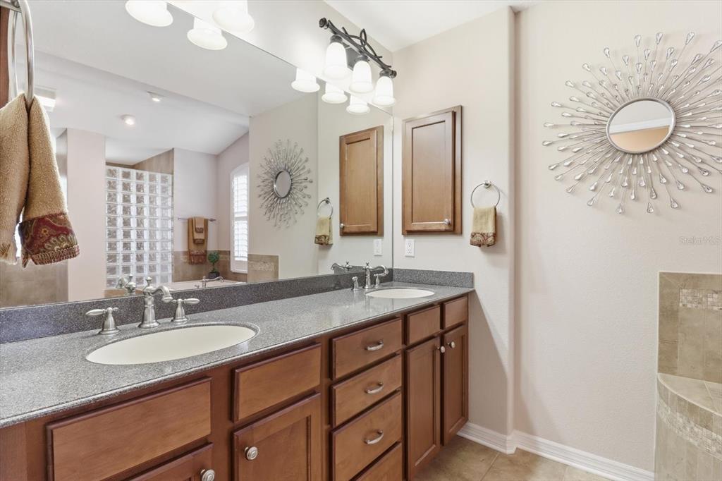6 Carnation Court Homosassa, FL 34446 - Photo 26 of 48 a bathroom with a granite countertop sink a toilet and a mirror