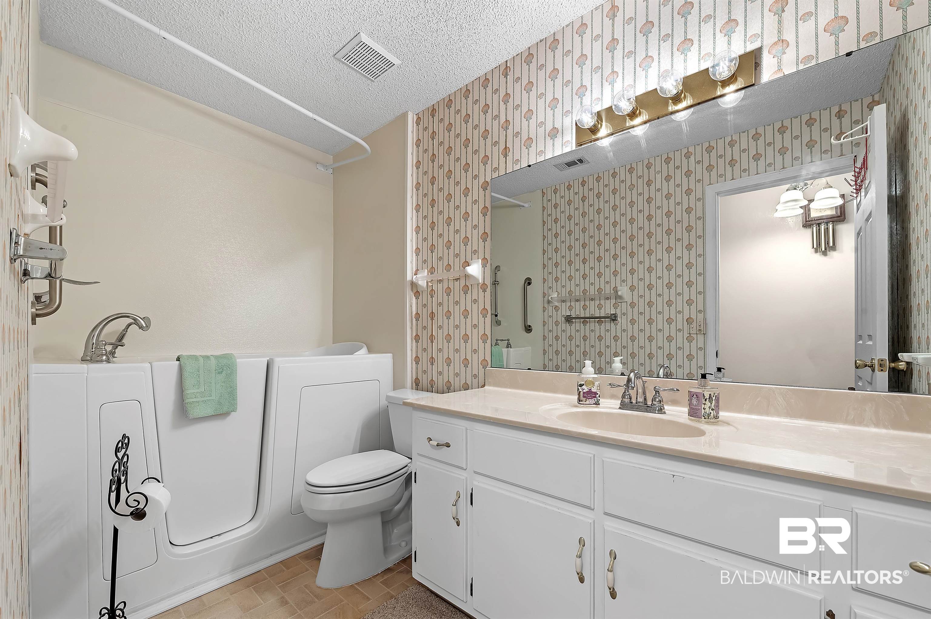 1502 Mulberry Lane Foley, AL 36535 - Photo 29 of 45 Bathroom with tile patterned flooring, toilet, vanity, and a textured ceiling