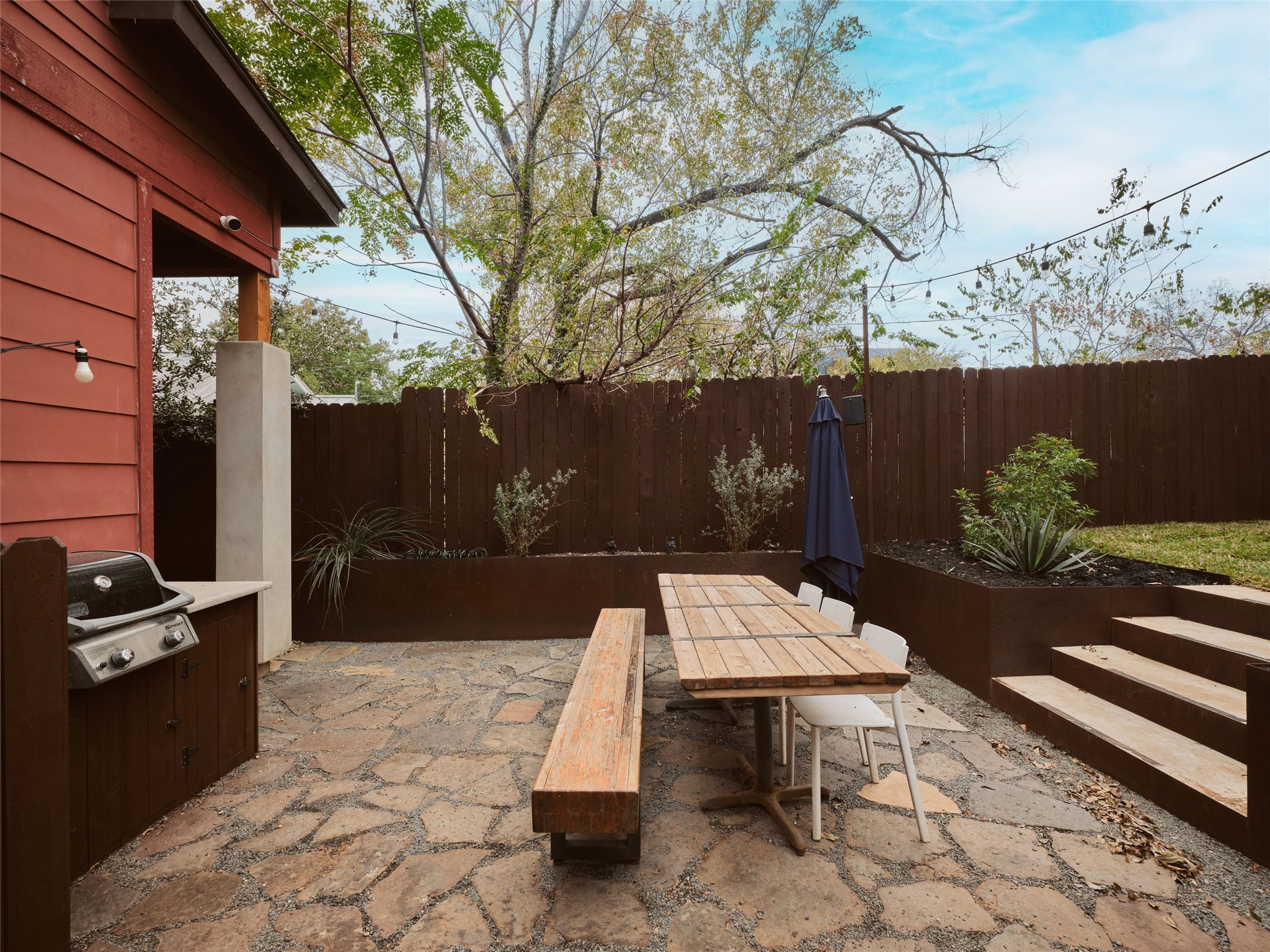 2002 East 13th Street, Unit A Austin, TX 78702 - Photo 31 of 37 Fenced backyard featuring a patio area, a grill, and outdoor dining area