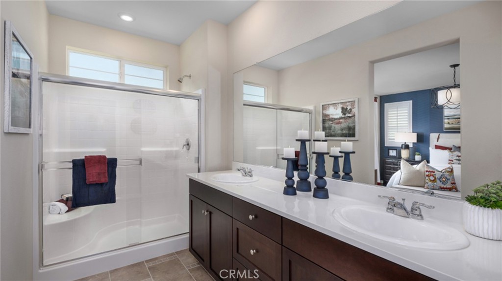 5222 Chaps Way Hemet, CA 92545 - Photo 6 of 15 a bathroom with a double vanity sink mirror and shower