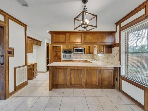 a kitchen with stainless steel appliances granite countertop a stove and a refrigerator
