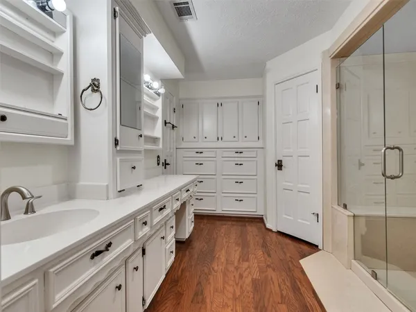 a large white kitchen with cabinets