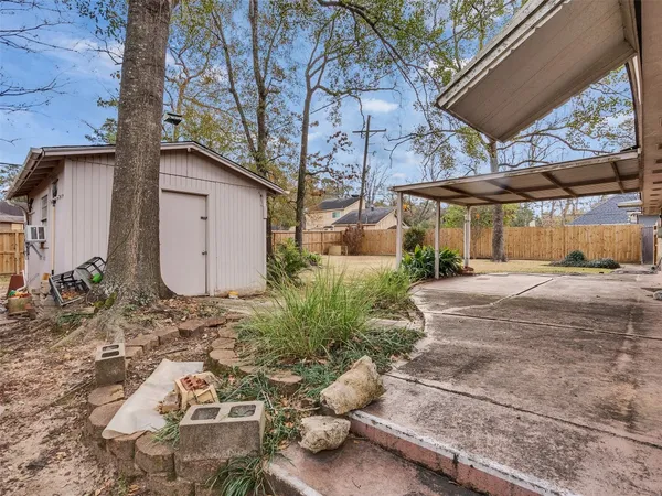an aerial view of a house with a backyard