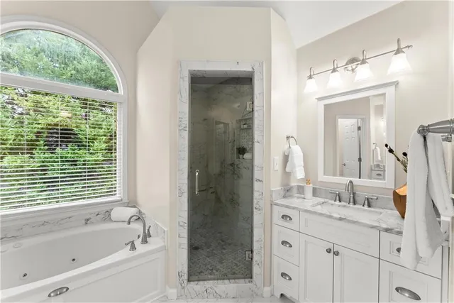 an aerial view of residential houses with outdoor space and lake view