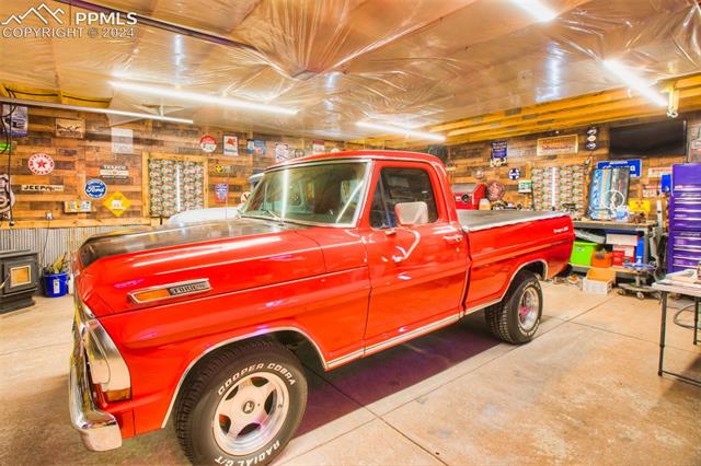 31 Wahsatch Road Florissant, CO 80816 - Photo 32 of 46 3 car detached garage with epoxy floor, insulated, heated and accented with corrugated metal and barn wood. Bring on the hobbyists!! Truck is not included:)