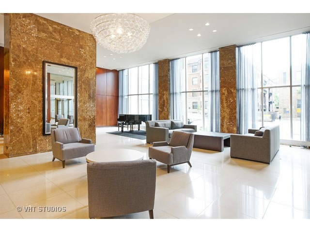 655 West Irving Park Road, Unit 4015 Chicago, IL 60613 - Photo 2 of 14 a living room with furniture and large windows