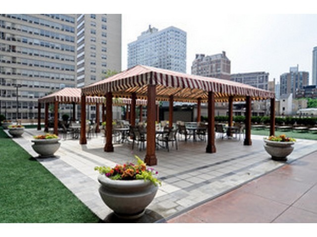 655 West Irving Park Road, Unit 4015 Chicago, IL 60613 - Photo 13 of 14 a view of a patio with dining table and chairs