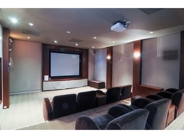 655 West Irving Park Road, Unit 4015 Chicago, IL 60613 - Photo 14 of 14 a living room with furniture and a projector