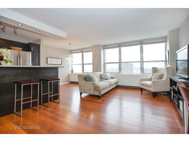 655 West Irving Park Road, Unit 4015 Chicago, IL 60613 - Photo 3 of 14 a living room with furniture and a fireplace
