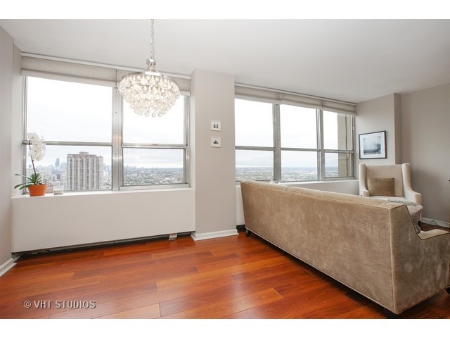 655 West Irving Park Road, Unit 4015 Chicago, IL 60613 - Photo 5 of 14 a living room with furniture and a large window