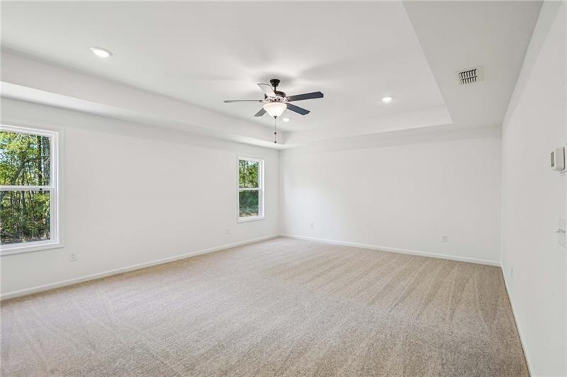 240 Silverleaf Trail Bethlehem, GA 30620 - Photo 11 of 35 an empty room with windows and chandelier fan