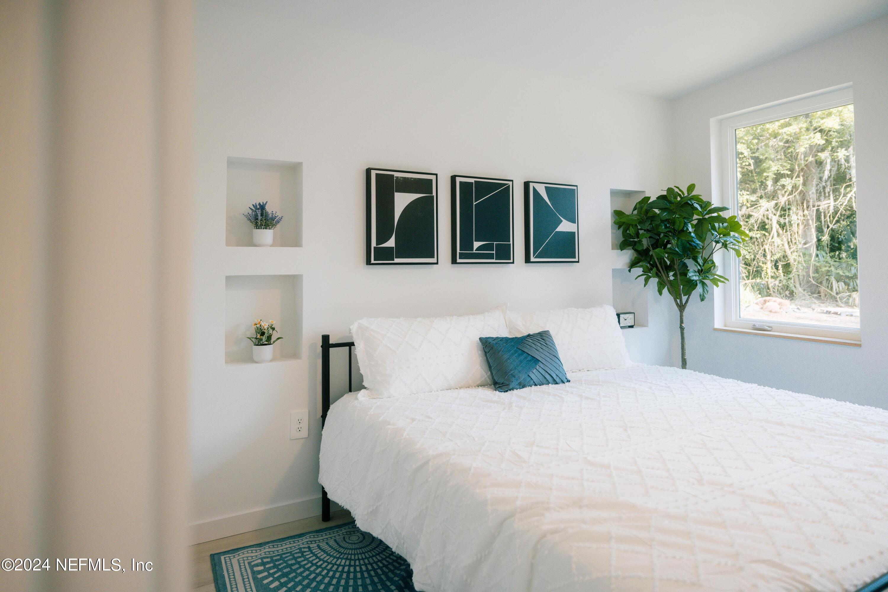 673 Julia Street St. Augustine, FL 32084 - Photo 15 of 21 a bedroom with a bed and a window