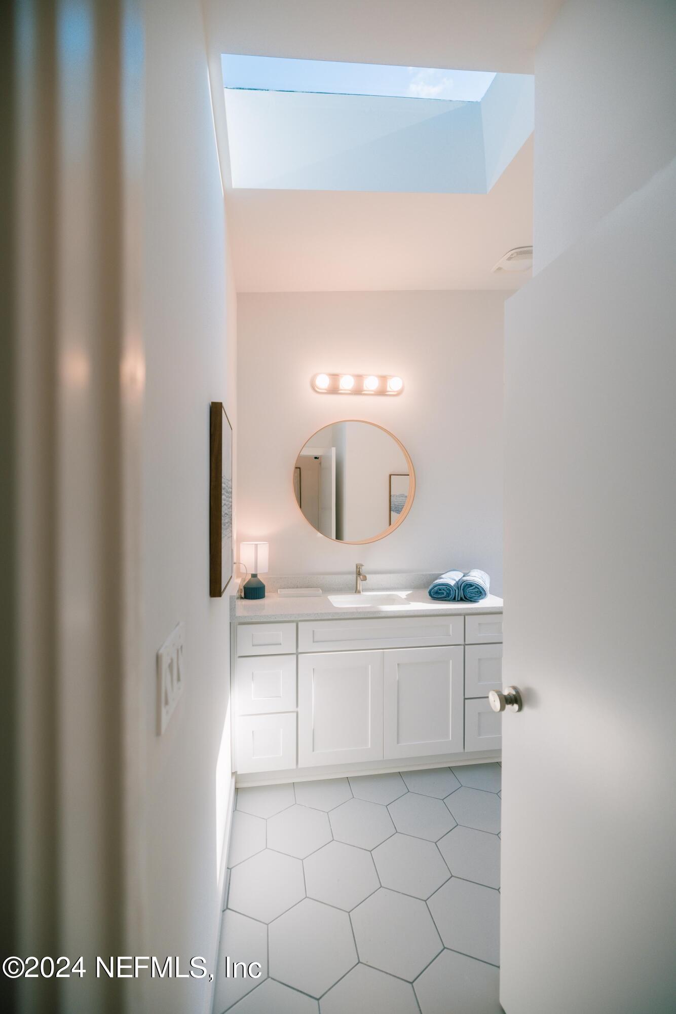 673 Julia Street St. Augustine, FL 32084 - Photo 16 of 21 a bathroom with a sink and a mirror
