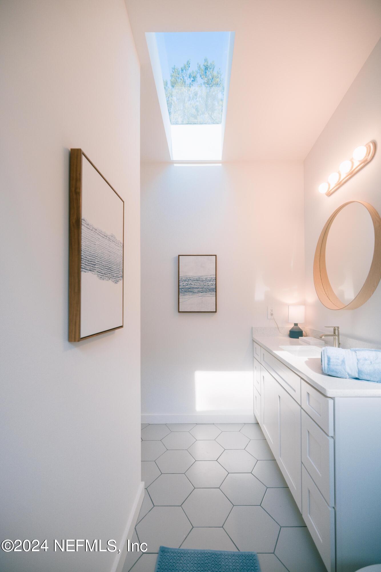 673 Julia Street St. Augustine, FL 32084 - Photo 17 of 21 a bathroom with a sink a toilet and mirror