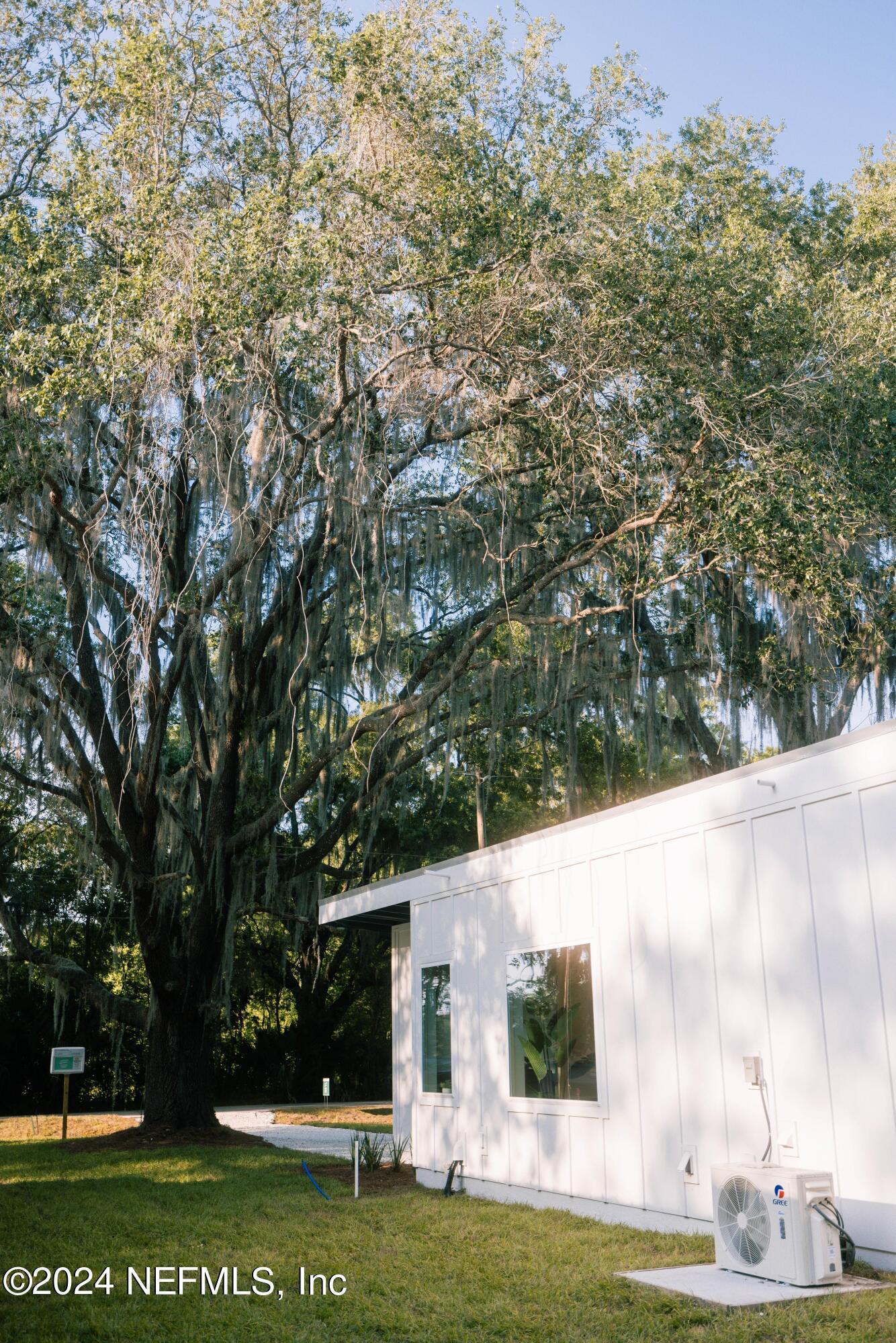 673 Julia Street St. Augustine, FL 32084 - Photo 20 of 21 a view of a white house with a big yard and large trees