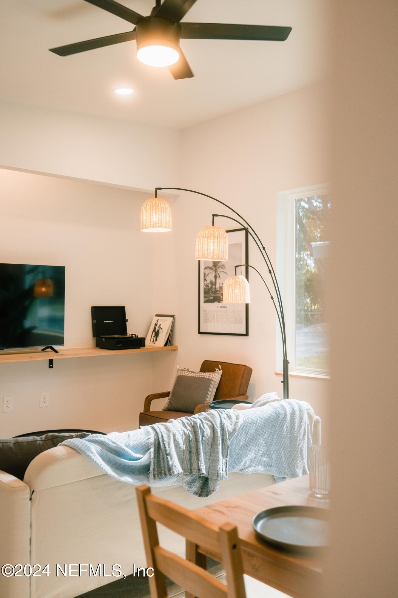 673 Julia Street St. Augustine, FL 32084 - Photo 3 of 21 a living room with a couch and a flat screen tv