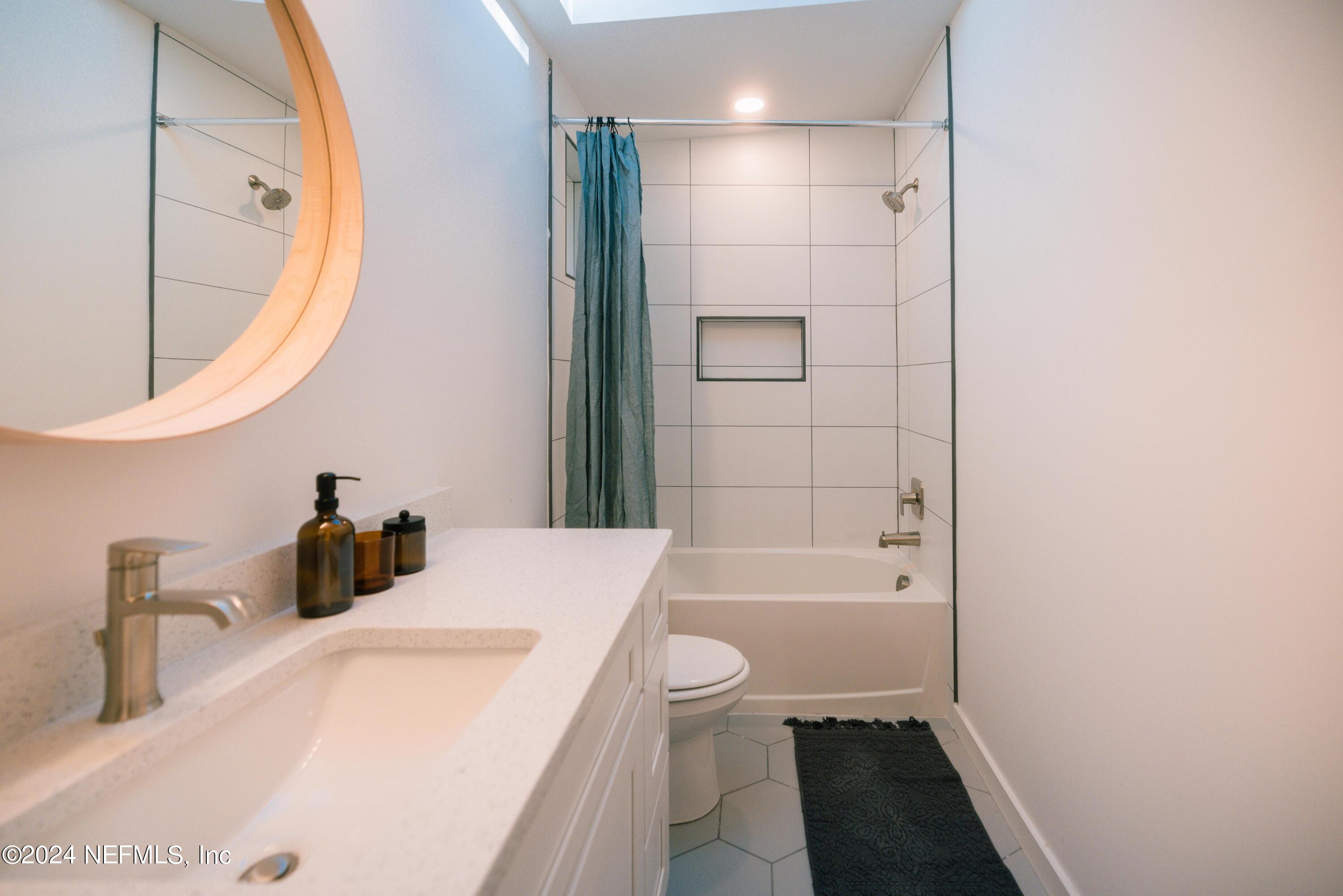 673 Julia Street St. Augustine, FL 32084 - Photo 9 of 21 a bathroom with a sink a toilet and a mirror