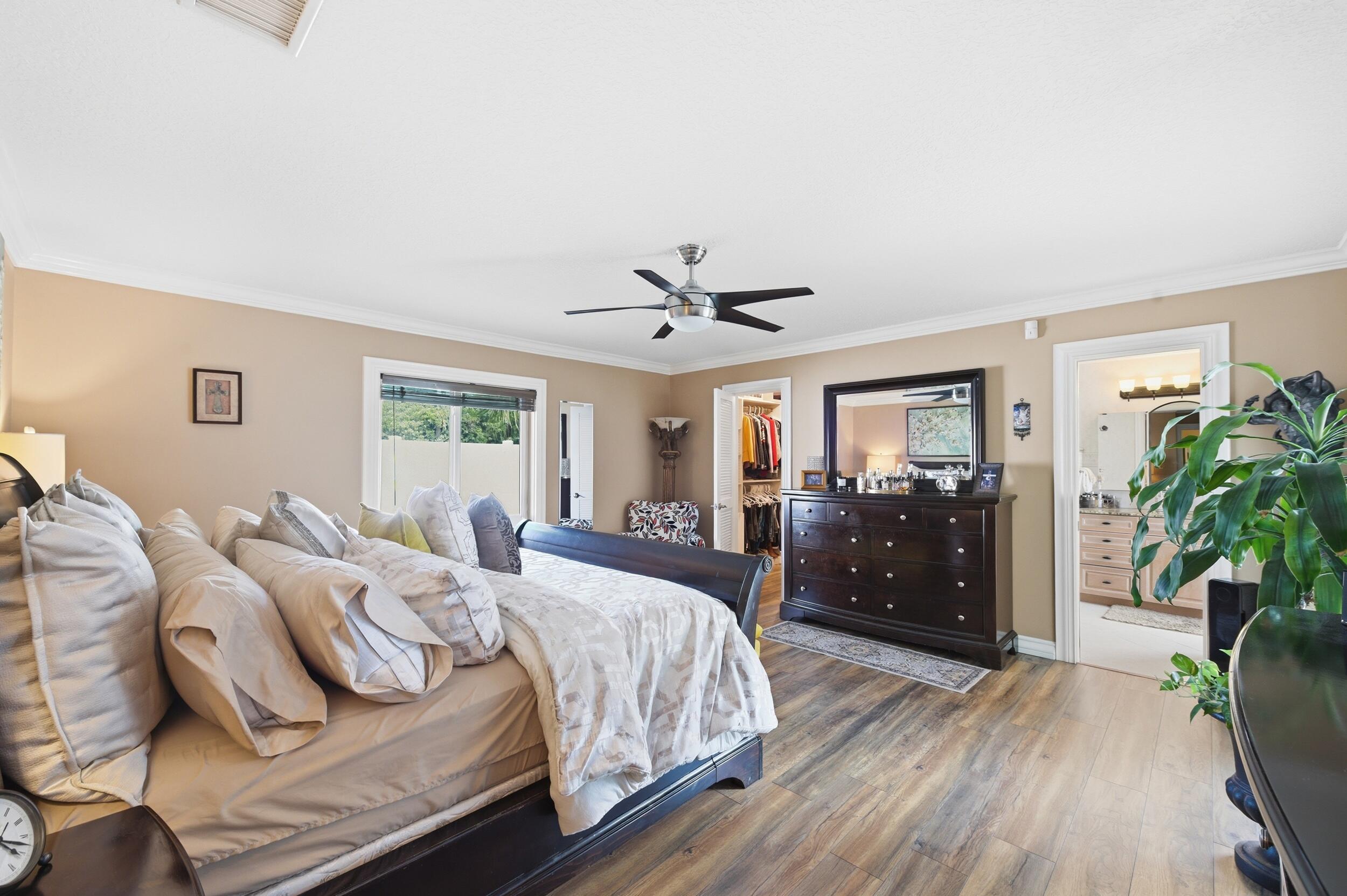 4780 Brandywine Drive Boca Raton, FL 33487 - Photo 15 of 43 a bedroom with a bed and ceiling fan