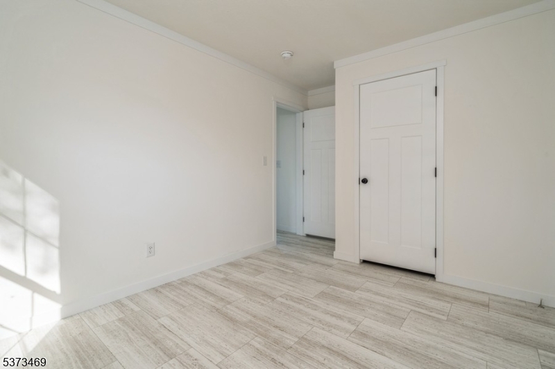 195 West Main Street, Unit 22 Chester, NJ 07930 - Photo 12 of 23 a view of an empty room with wooden floor and a window