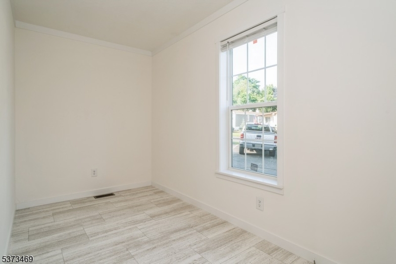 195 West Main Street, Unit 22 Chester, NJ 07930 - Photo 15 of 23 an empty room with wooden floor and windows