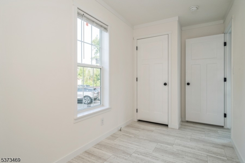 195 West Main Street, Unit 22 Chester, NJ 07930 - Photo 16 of 23 a view of an empty room with a window and wooden floor