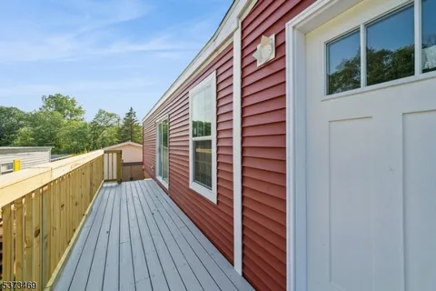 a balcony with wooden floor and fence