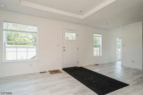 a view of a livingroom with wooden floor and a window