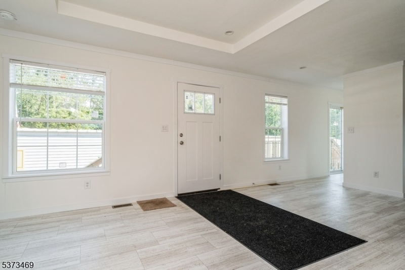 195 West Main Street, Unit 22 Chester, NJ 07930 - Photo 2 of 23 a view of a livingroom with wooden floor and a window