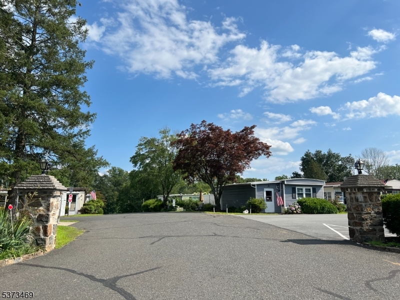 195 West Main Street, Unit 22 Chester, NJ 07930 - Photo 22 of 23 a front view of a house with a yard and trees