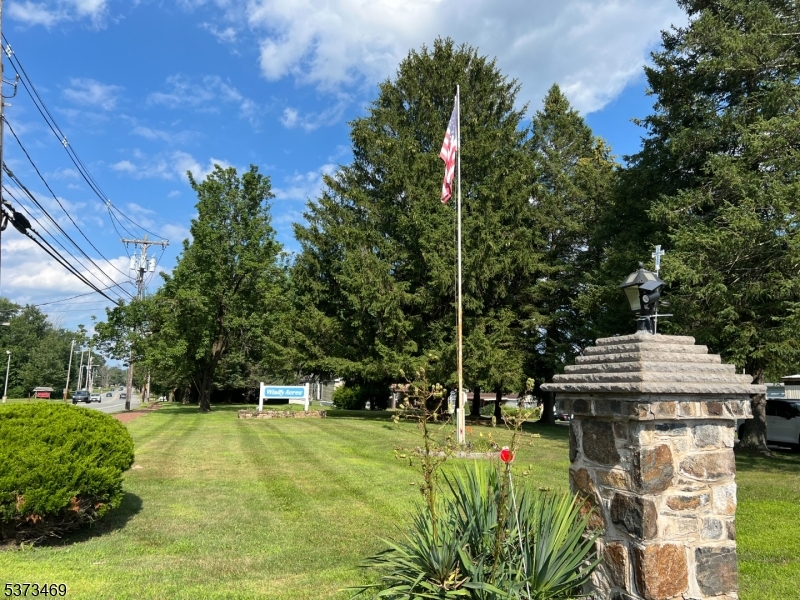 195 West Main Street, Unit 22 Chester, NJ 07930 - Photo 23 of 23 a garden with trees in front of it