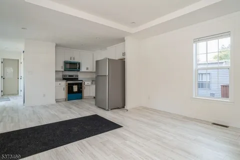 a kitchen with stainless steel appliances a refrigerator sink and stove