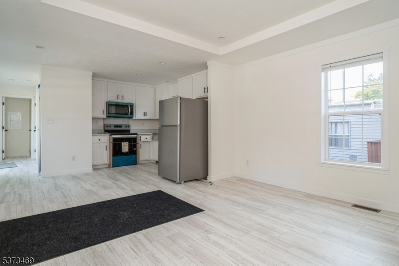 195 West Main Street, Unit 22 Chester, NJ 07930 - Photo 5 of 23 a kitchen with stainless steel appliances a refrigerator sink and stove