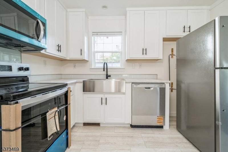 195 West Main Street, Unit 22 Chester, NJ 07930 - Photo 7 of 23 a kitchen with stainless steel appliances a stove a refrigerator and cabinets