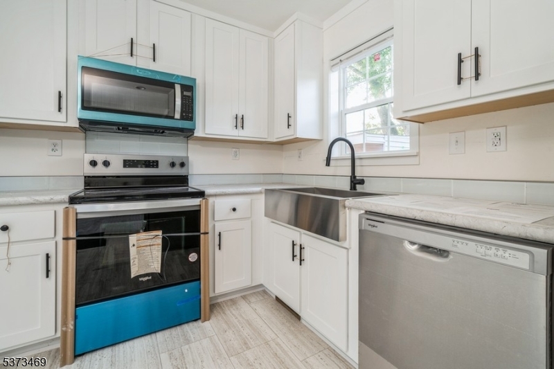 195 West Main Street, Unit 22 Chester, NJ 07930 - Photo 8 of 23 a kitchen with stainless steel appliances a stove sink and microwave