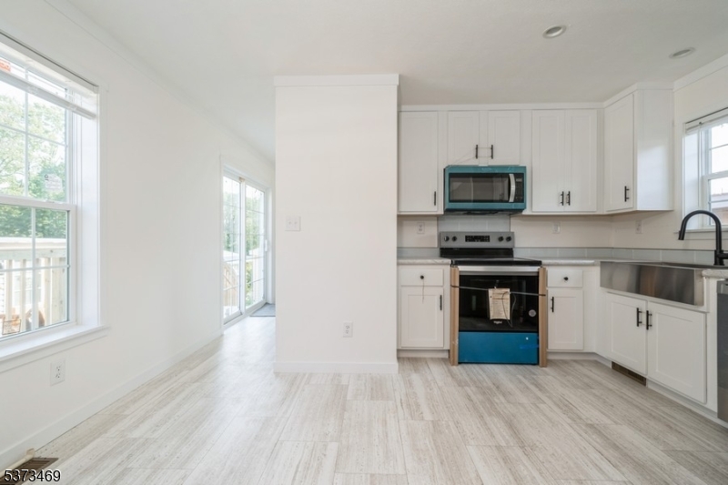 195 West Main Street, Unit 22 Chester, NJ 07930 - Photo 9 of 23 a kitchen with stainless steel appliances a stove top oven a sink a counter space and cabinets