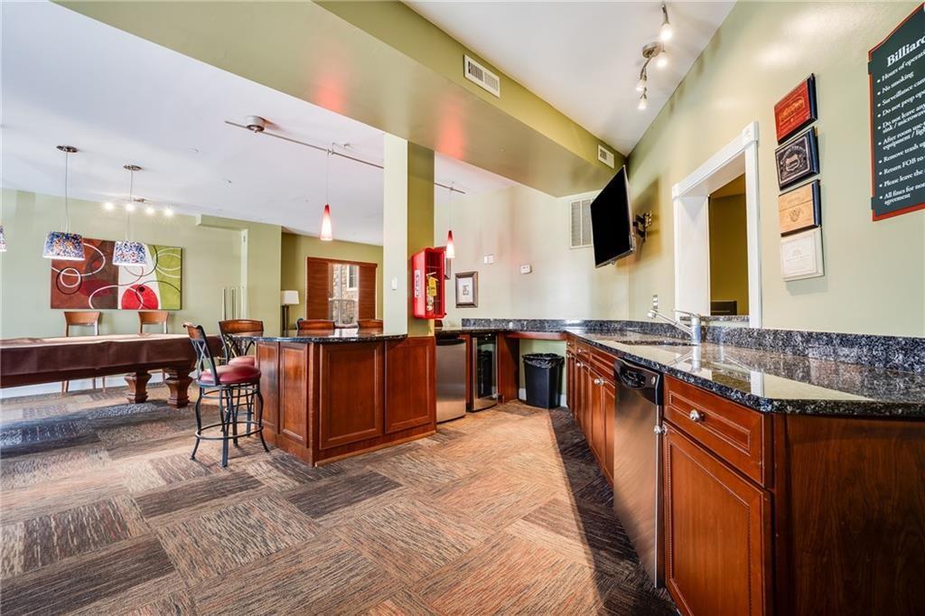 10 Perimeter Summit Boulevard, Unit 1404 Brookhaven, GA 30319 - Photo 30 of 39 a large kitchen with stainless steel appliances lots of counter top space
