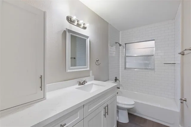 a bathroom with a tub sink and mirror