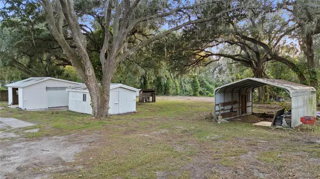 a view of a house with a tree in a yard