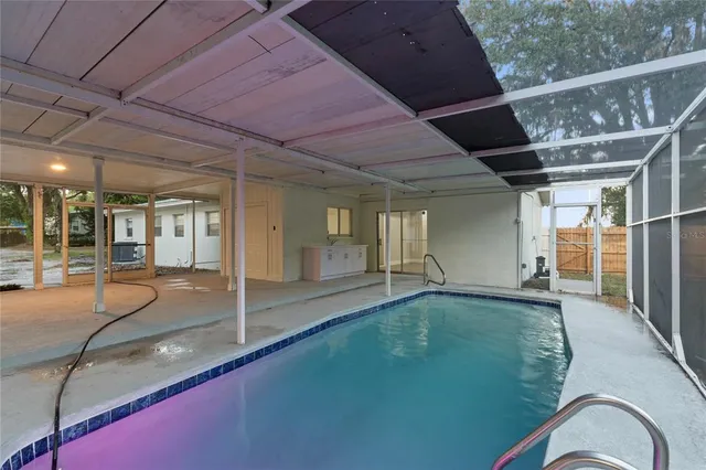 a view of a yard in front of a house with large tree