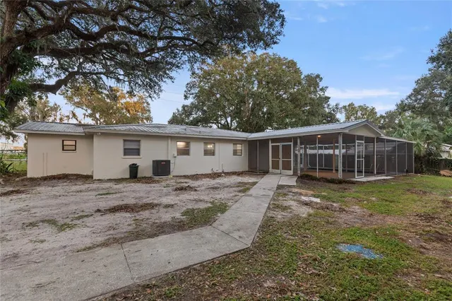a kitchen with kitchen island white cabinets and stainless steel appliances