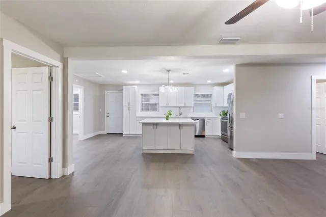 a view of kitchen with refrigerator and window