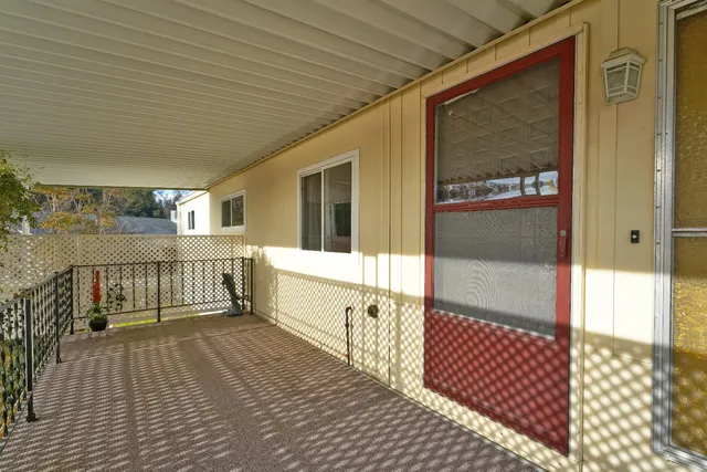 a view of a balcony with wooden floor