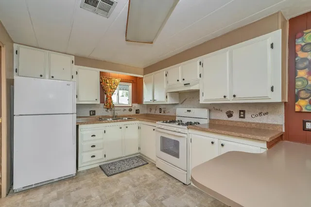 a kitchen with cabinets appliances and a counter space