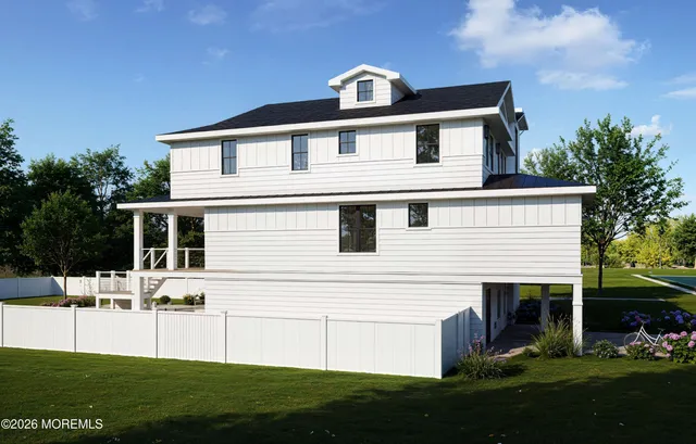 a front view of a house with a garden and yard